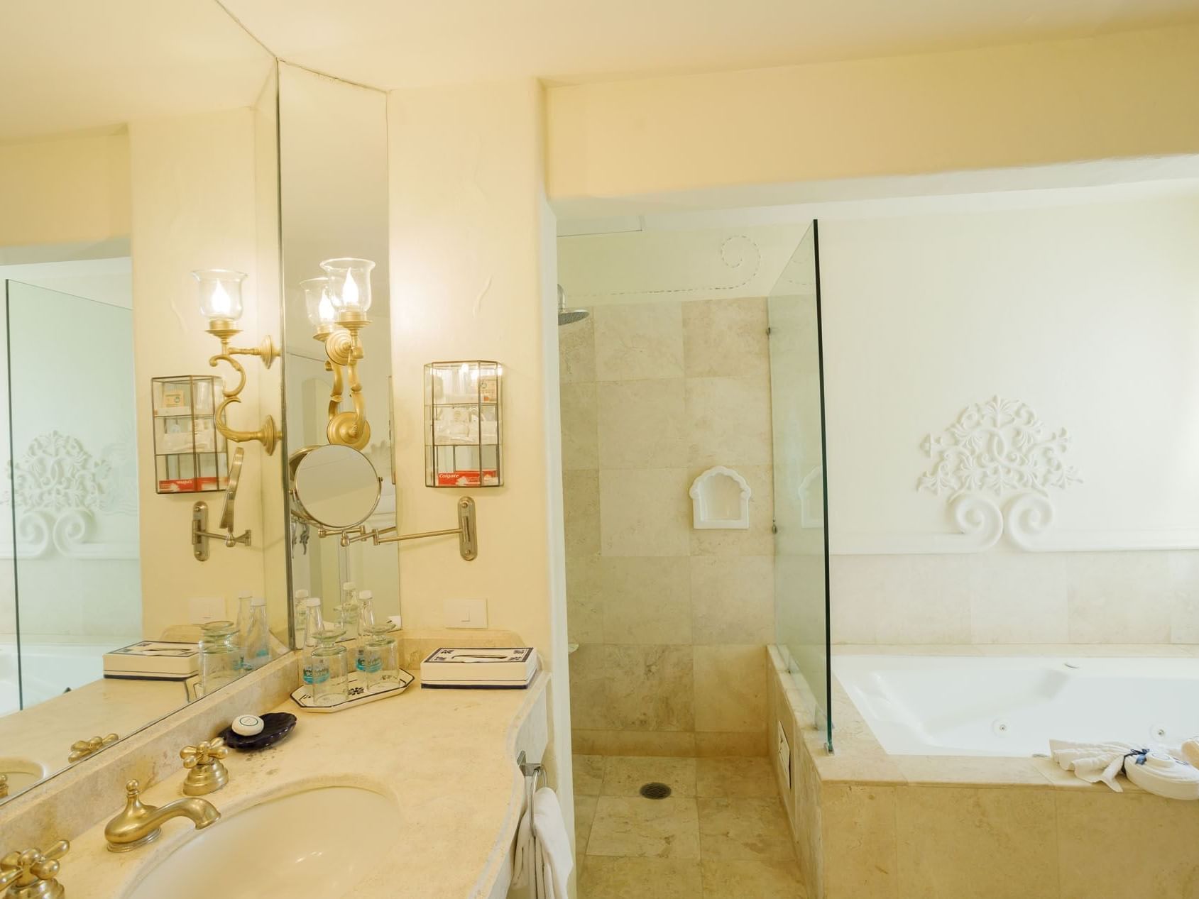 King Presidential Suite bathroom featuring a glass shower, soaking tub, and gold-tone fixtures at Quinta Real Acapulco