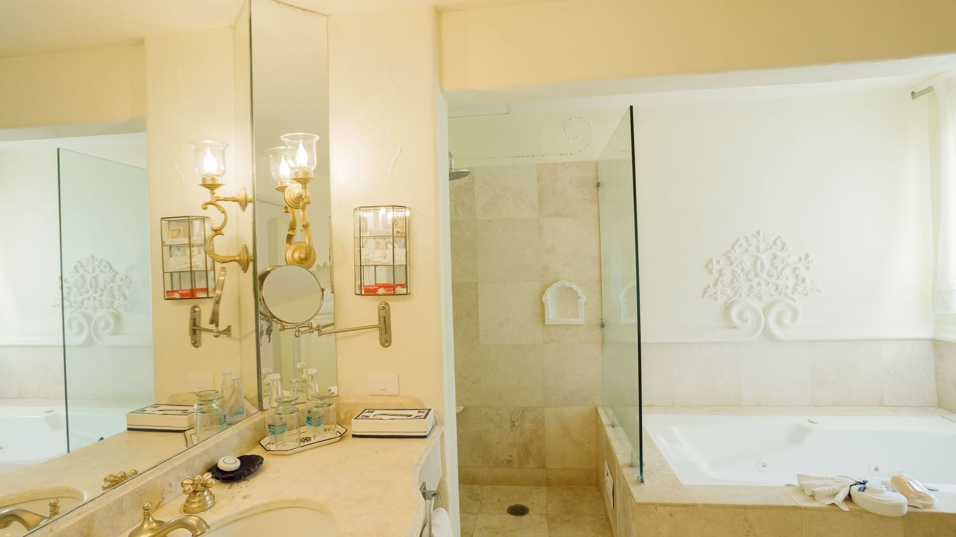 King Presidential Suite bathroom featuring a glass shower, soaking tub, and gold-tone fixtures at Quinta Real Acapulco