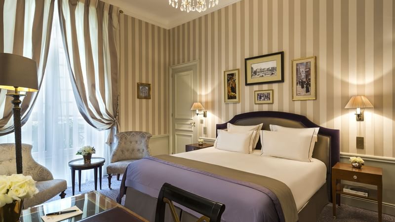 Large bed with lamps and work area in Executive Room at Hôtel Westminster - Paris
