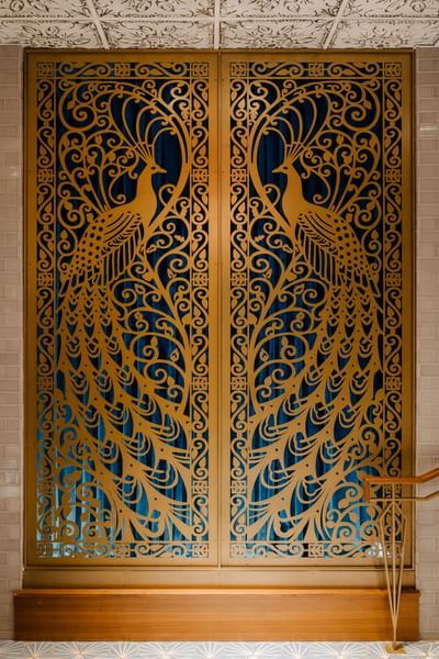 Gold peacock-patterned screen with fine swirls at Hotel Bijou, one of the top hotels in Downtown San Francisco