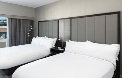 room with two beds and grey headboards