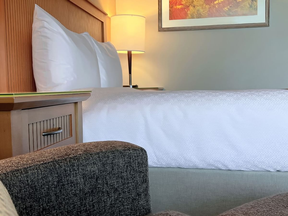 Side view of queen bed in guest room