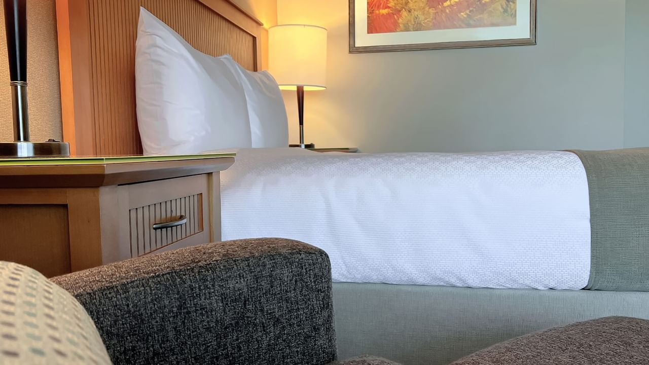 Side view of queen bed in guest room