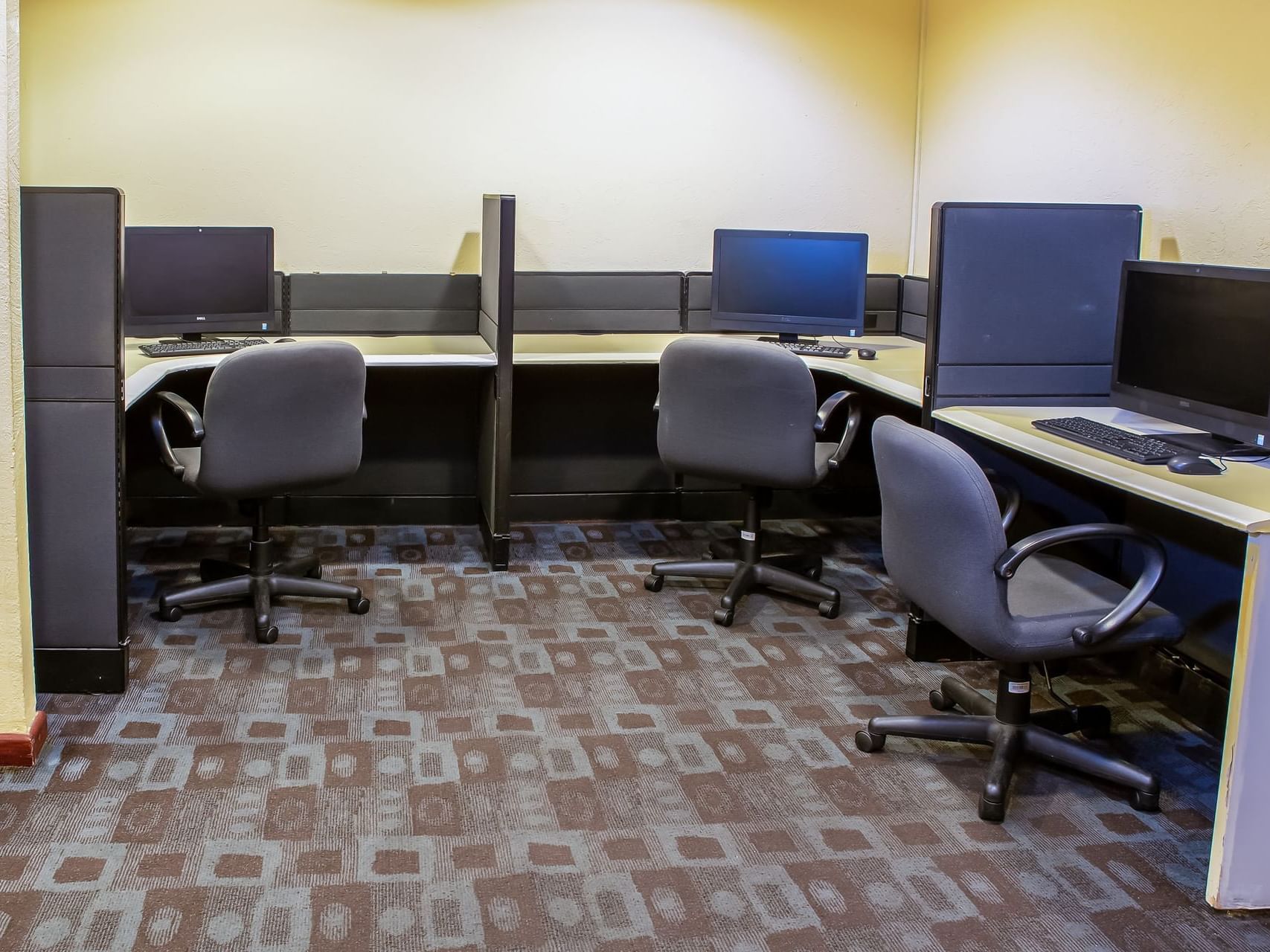 Computers, tables & chairs in a business center at Fiesta Inn