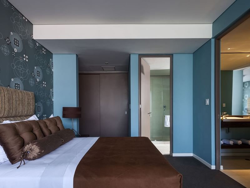 Large bed & wall mirror in the Master Suite at Gamma Hotels