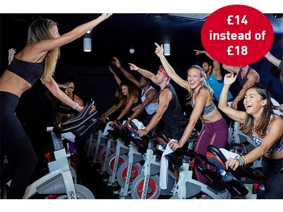 A group doing a cycling workout in Boom Cycle near Hotel Luma