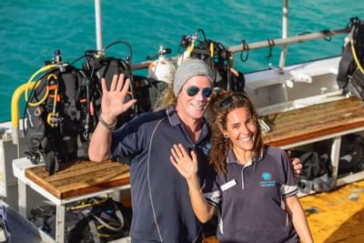 A couple on a boat with diving gear near Heron Island Resort