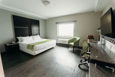 Bed, wall TV & work table in Standard Room at Araiza San Luis