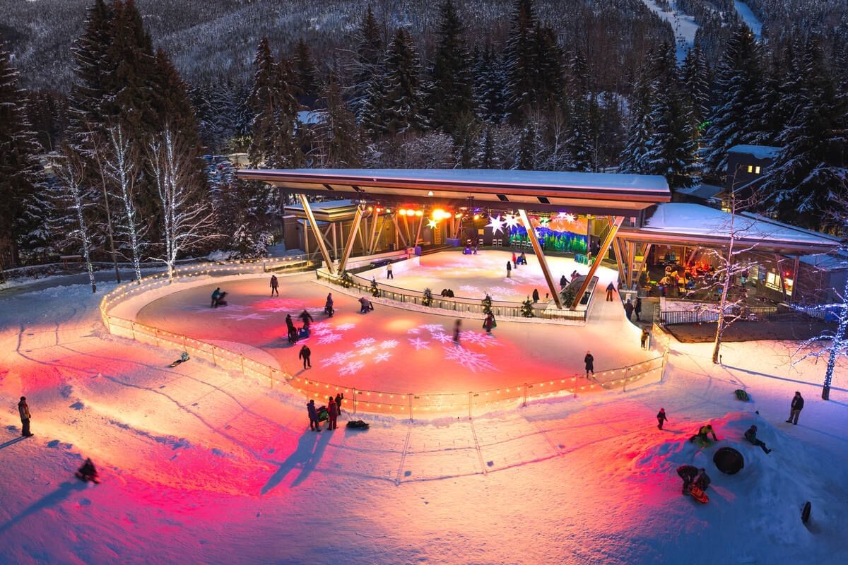 Aerial view of illuminated ice skating area near Blackcomb Springs Suites