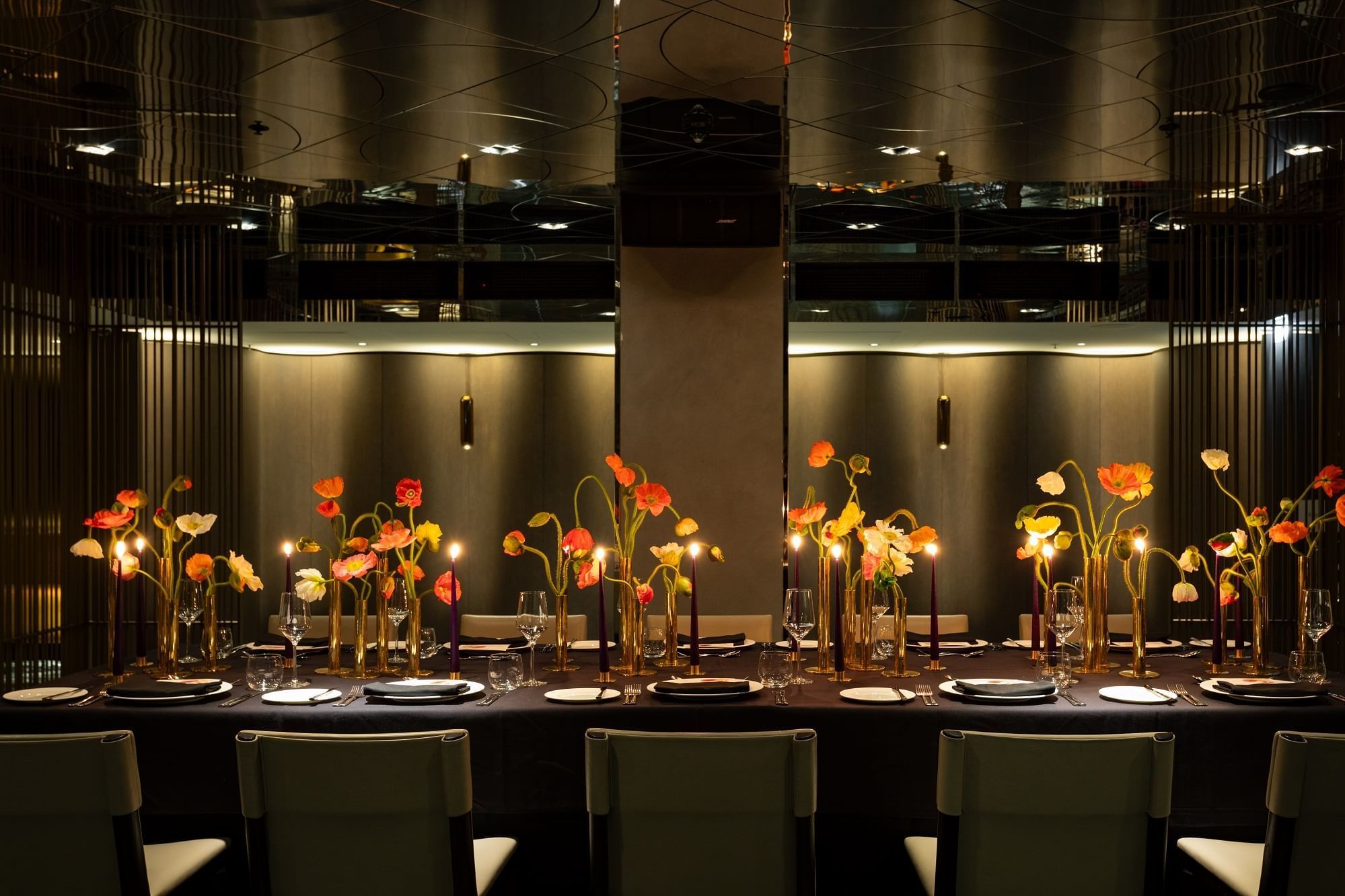 Dining table arrangement in The Green Room at The Londoner Hotel, adorned with vibrant floral arrangements