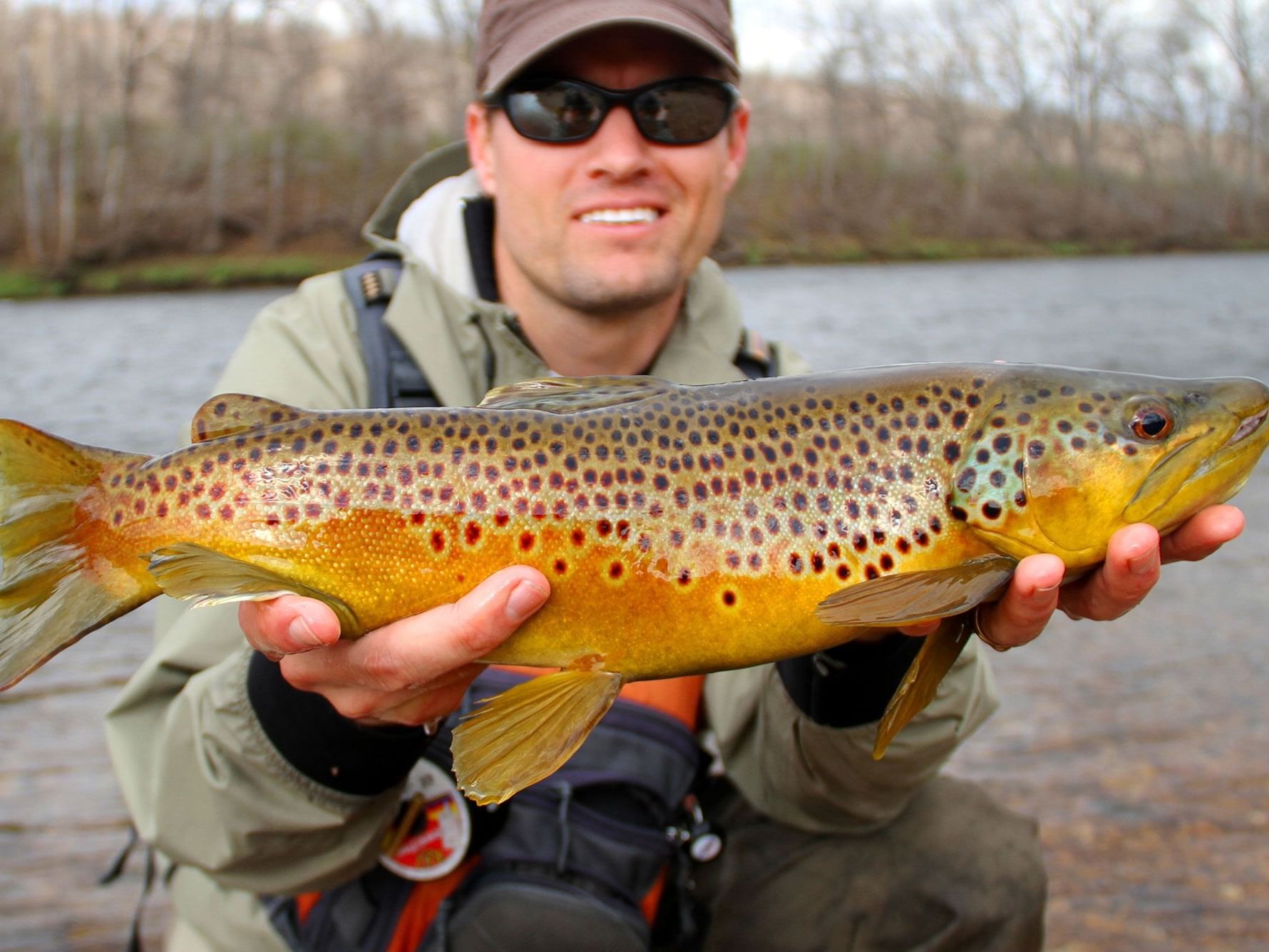 Man holding a brown trout near High Peaks Resort