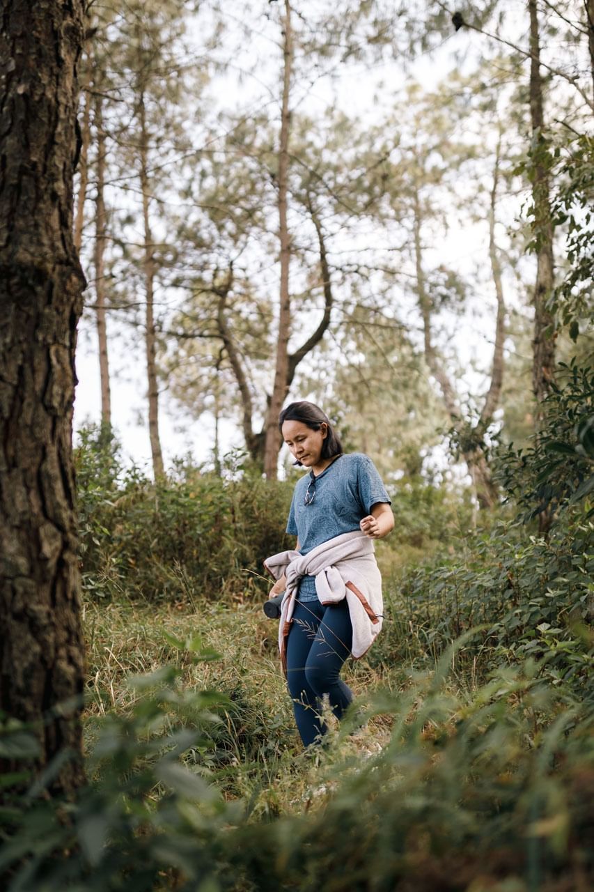 Women hiking in the forest with a jacket tied around the waist near The Terraces Resort & Spa