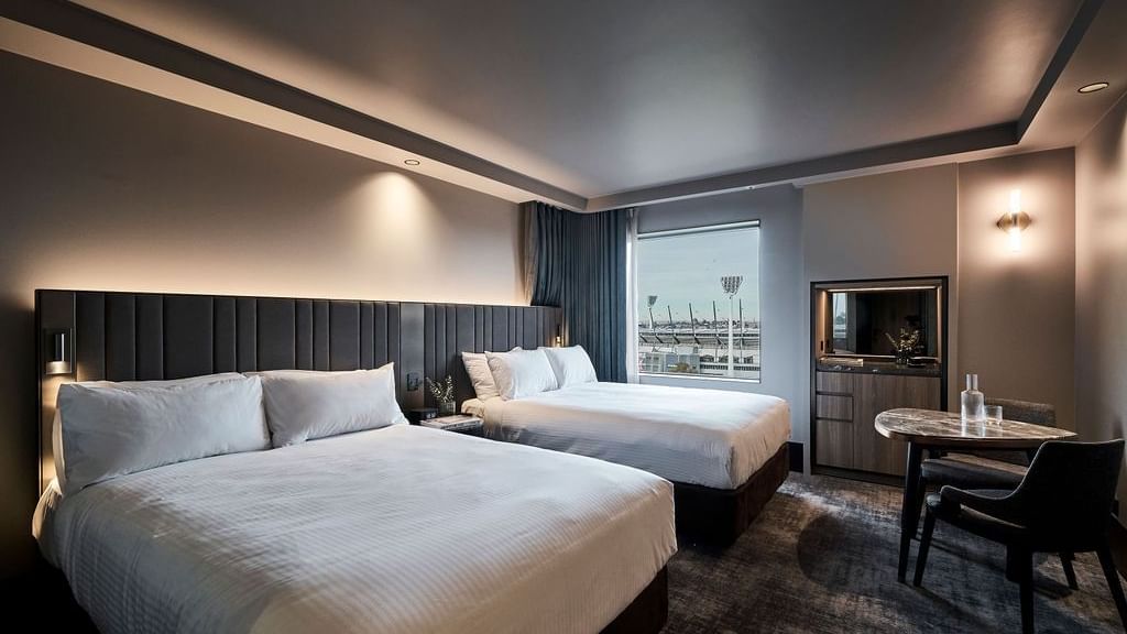 Superior room with two double beds, modern furnishings, and stadium views at Pullman East Melbourne