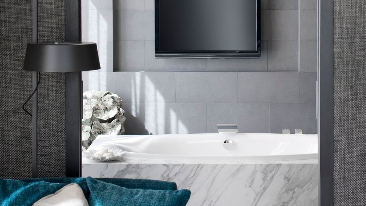 Tv & bathtub in The Apartment bathroom at Crown Melbourne