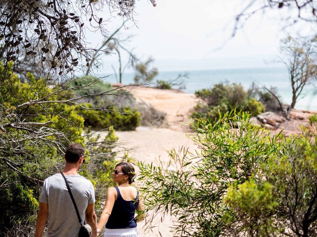 Couple on a walk near the beach at Freycinet Lodge
