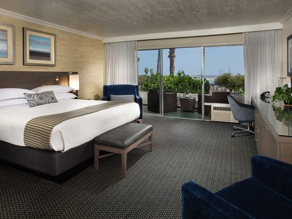 King bed in spacious hotel room with habor view