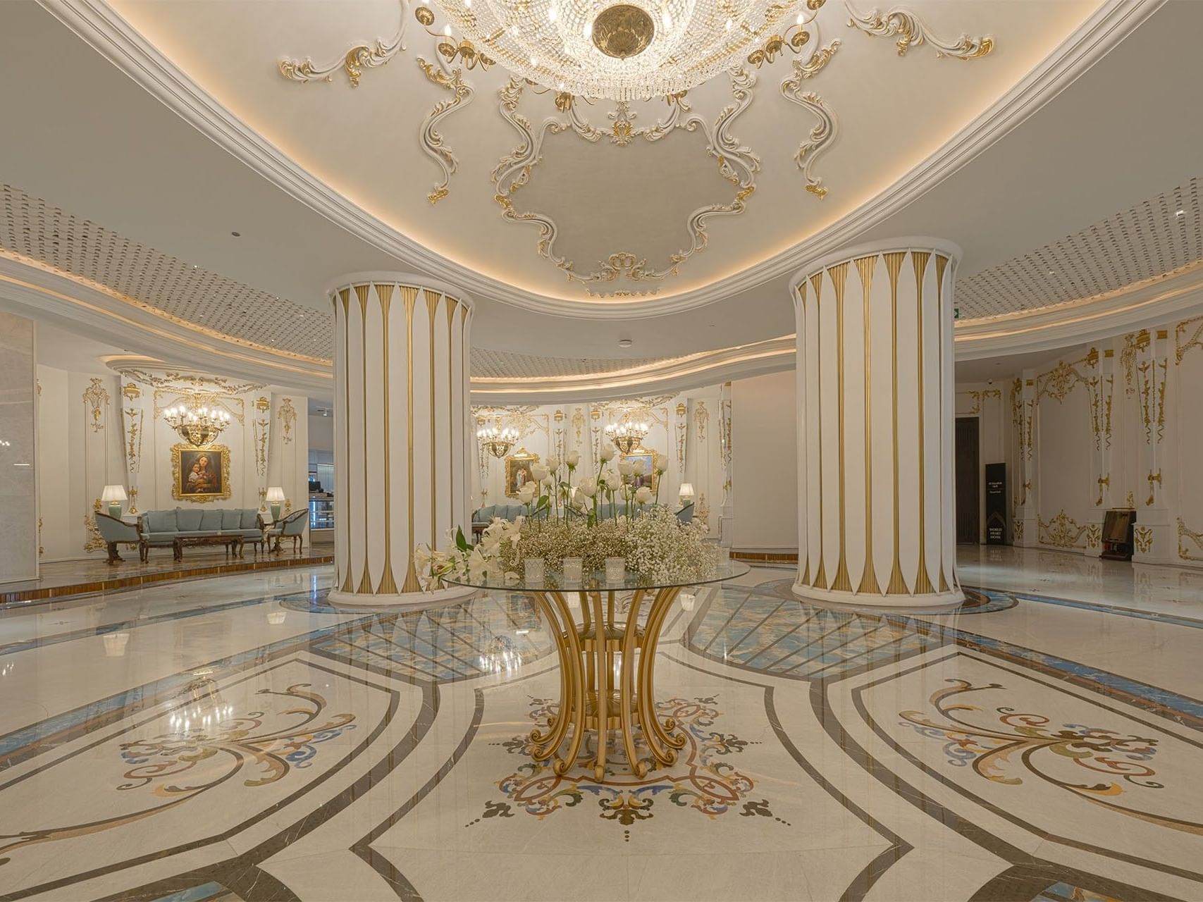 Luxurious lobby with ornate decorations, gold accents, and grand chandelier at World Heart Hotel Baghdad.