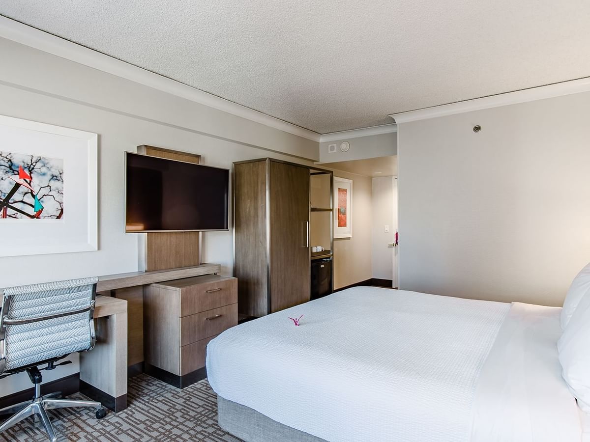 Accessible hotel guestroom with king bed, TV, and desk