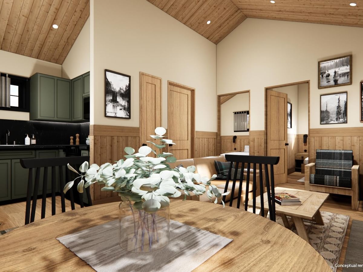 Whistler Cabin interior with wood-paneled ceiling, dining area, kitchen, and cozy seating.