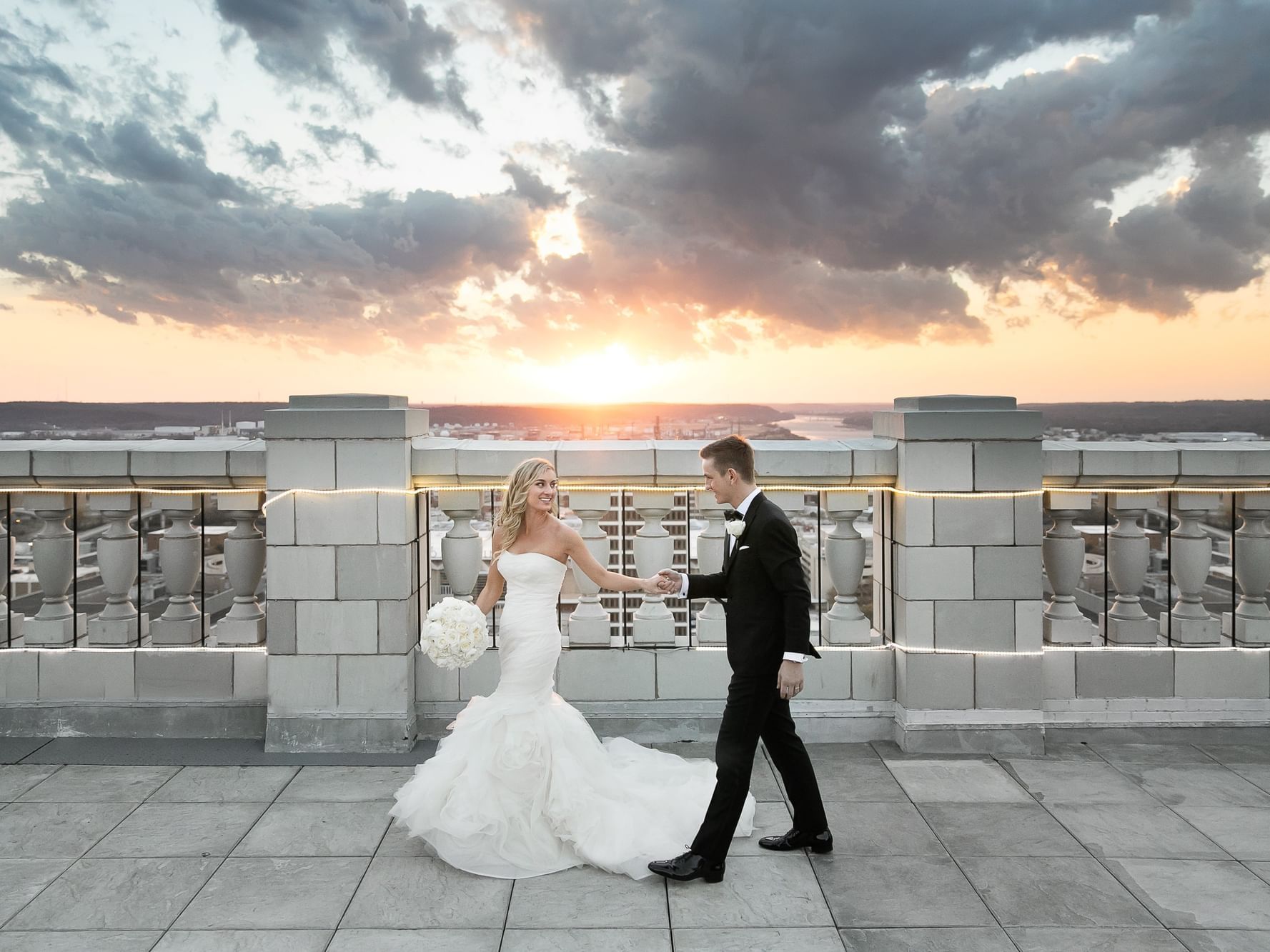 Wedded couple posing on rooftop at The Mayo Hotel