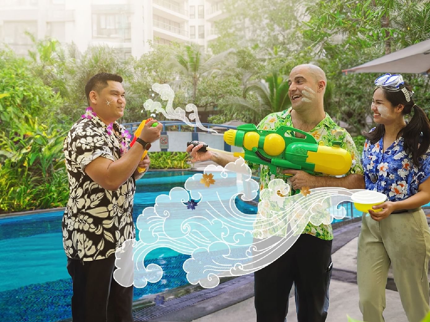 Three people wearing Hawaiian shirts, enjoy a Songkran Splash 