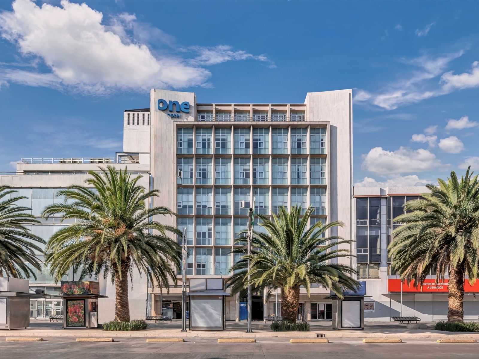 Exterior view of the Hotel, car park & palm trees at One Hotels