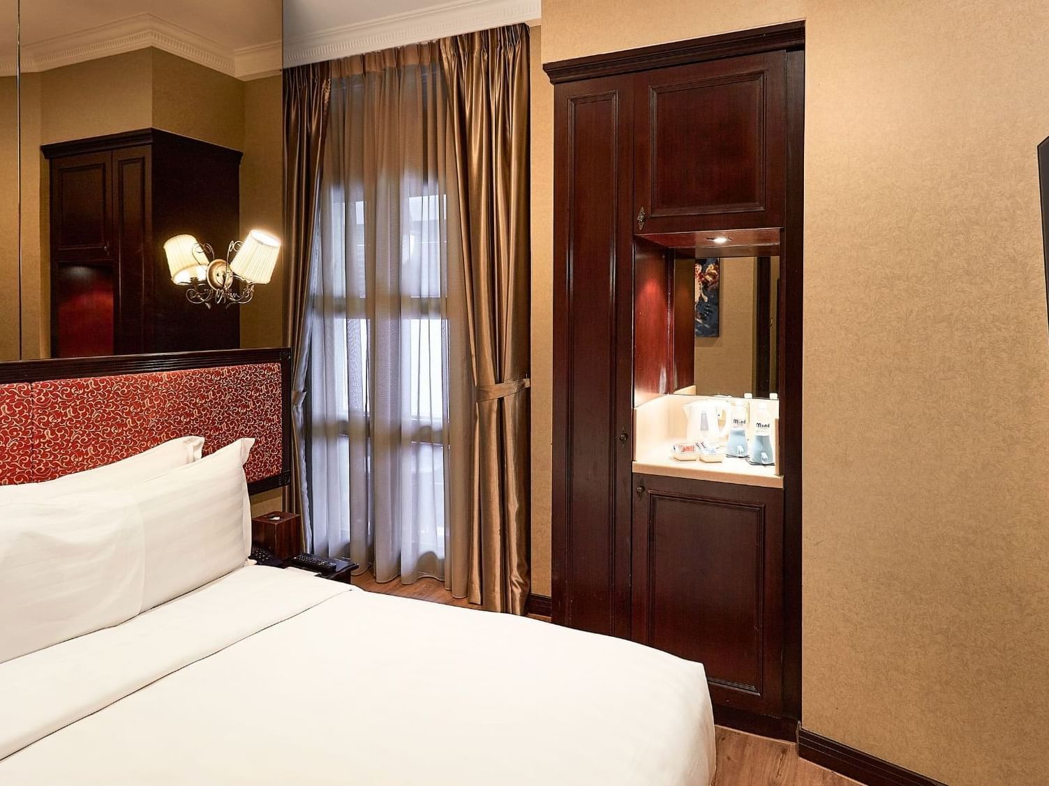 Bed & TV in Balcony Room at Nostalgia Hotel Singapore
