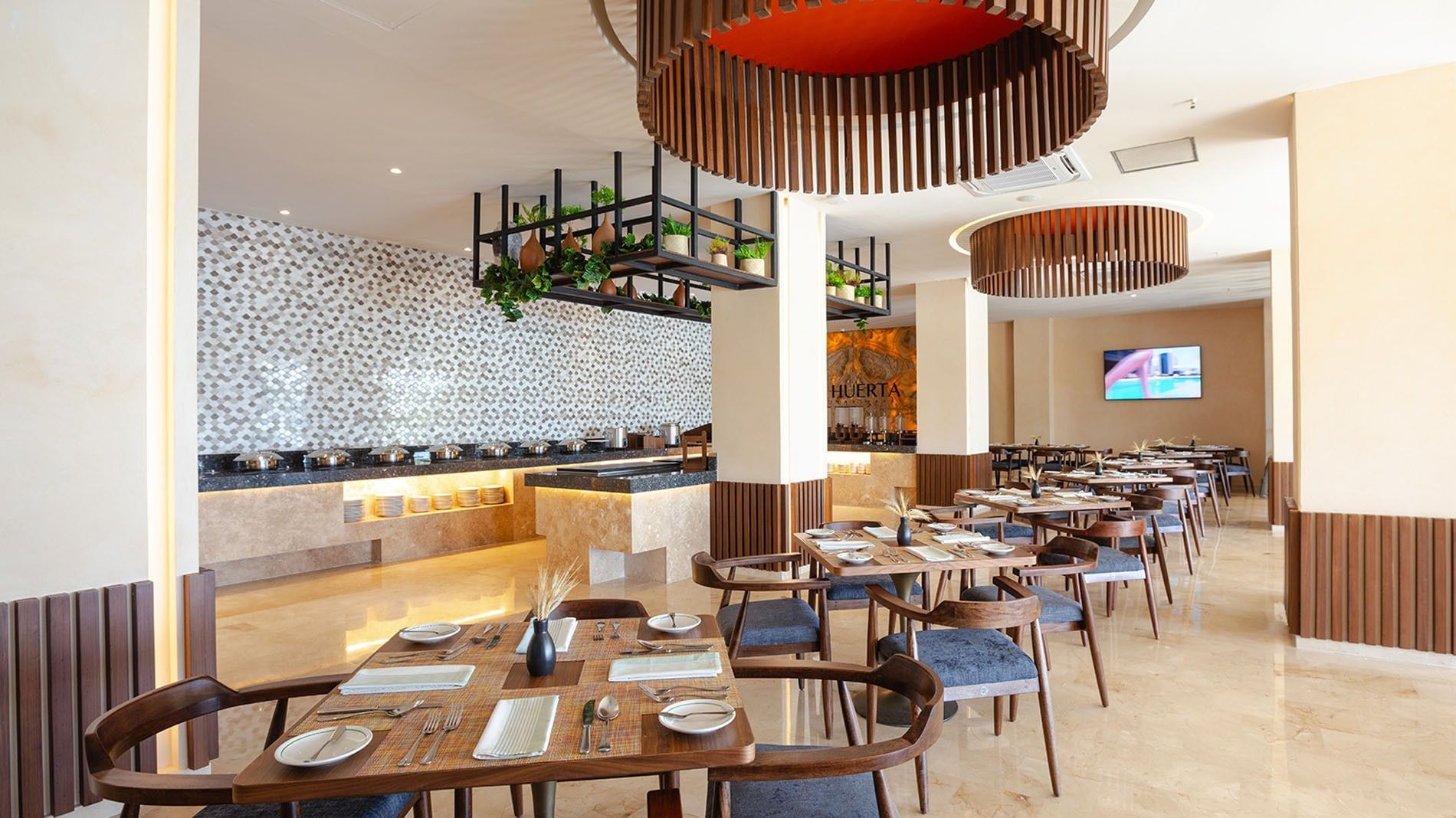 Spacious dining room with contemporary wooden light fixtures in La Huerta at Camino Real Acapulco Diamante
