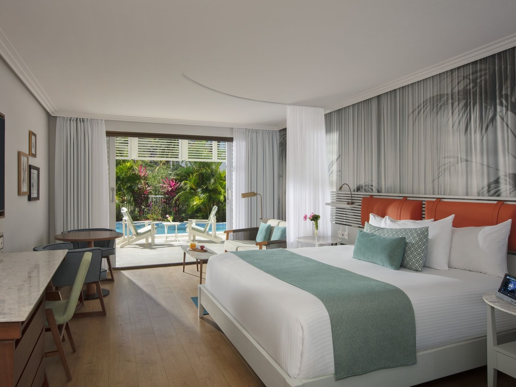 Workspace & cozy seating area by the cozy bed in Marina King Bed Suite with Swim Out Pool Access at St. Martin Beach Resort