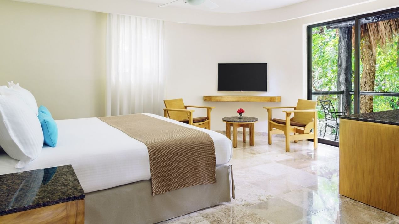 Comfy bed and TV in Premium room at The Reef Playacar 