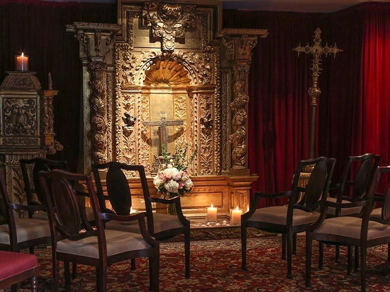 altar with flowers and chairs