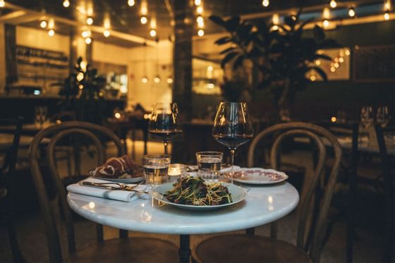 Wine & meals on an outdoor dining table at The Sparrow Hotel