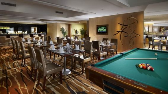 Dining tables and chairs arranged in a restaurant at Grand Park Wuxi