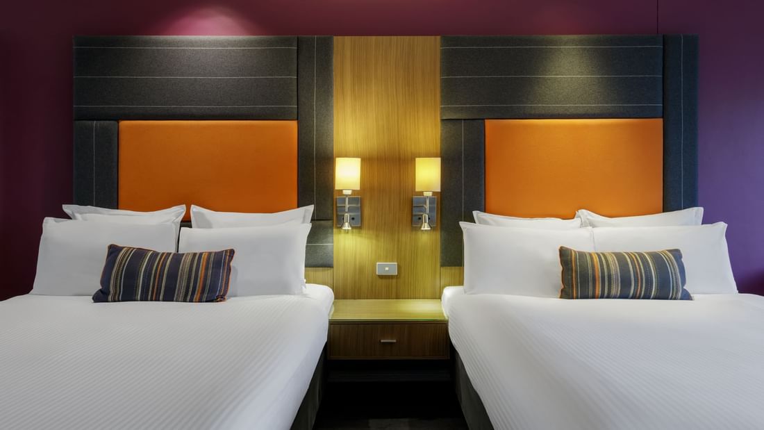Comfy beds & lamps in Classic Double Room with carpeted floors at Pullman Sydney Hyde Park