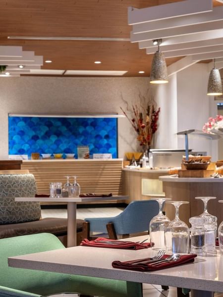 Buffet area with bread baskets by a blue scale-pattern wall in Verandah at Warwick Paradise Island Bahamas