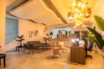 Lobby area with eclectic lighting, seating space, and a reception desk at Panama hotel