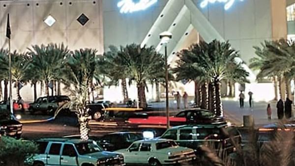 Al Rashid Mall by palm trees under a night sky, surrounding a busy parking area near Naviti by Warwick Al Khobar