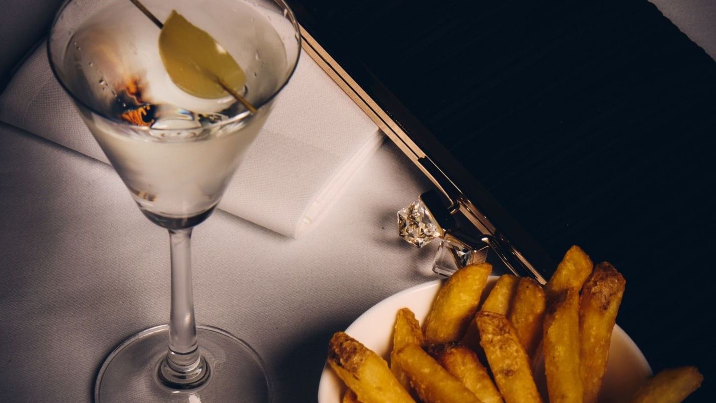 Martini and fries on a table at The Londoner in London.