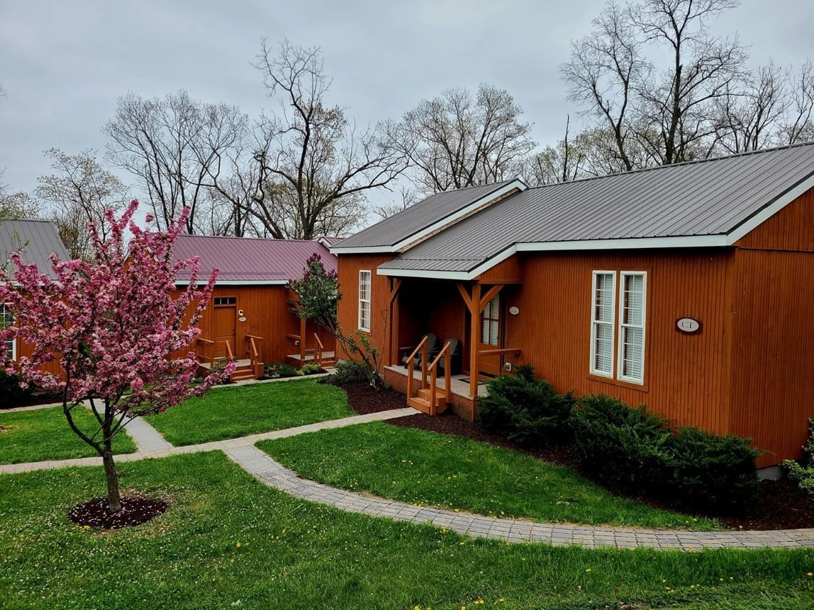 North and South Lodges surrounded by grass, a pathway, and trees at The Lodges ad Gettysburg in PA.