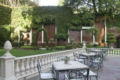 Dining area in the garden at Hotel Emperador Buenos Aires