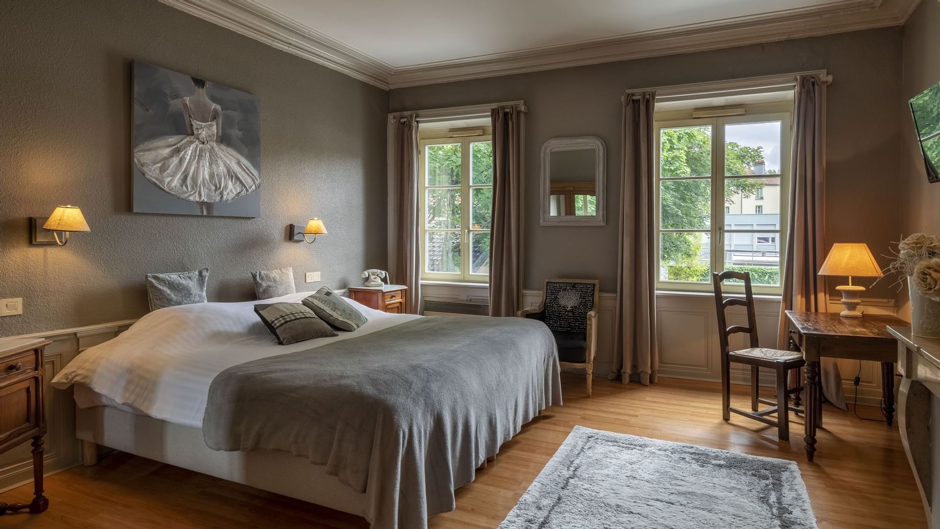 Bedroom interior with king bed & desk at The Originals Hotels