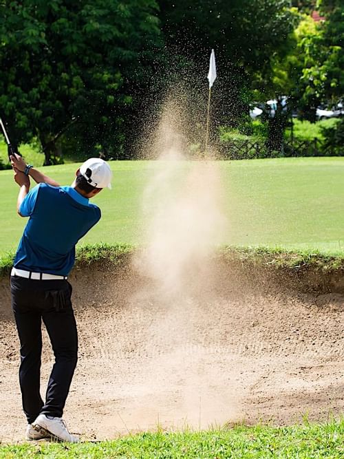 Man playing golf at the golf course in Princess Mundo Imperial