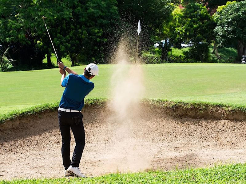 Man playing golf at the golf course in Princess Mundo Imperial