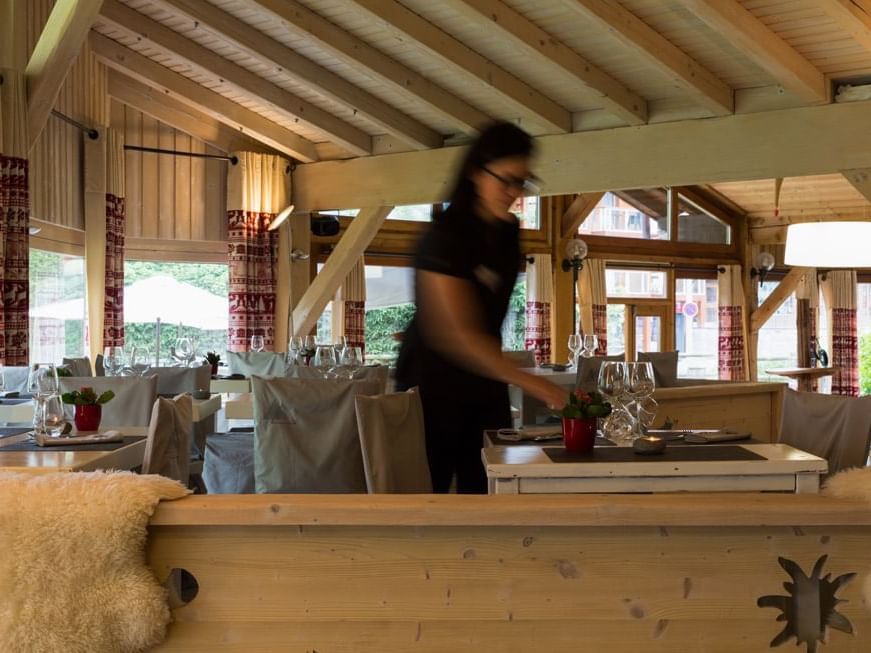 Women arranging a dining table at The Originals Hotels