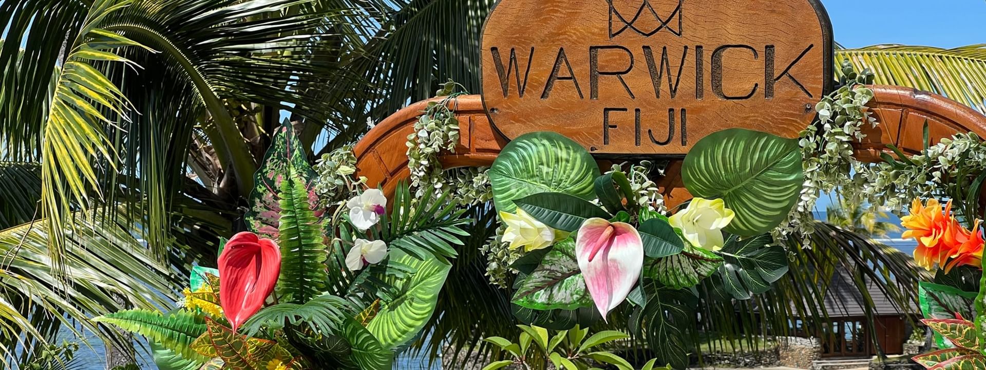 Tropical entrance decorated with flowers and greenery at Warwick Fiji Resort and Spa in Korolevu