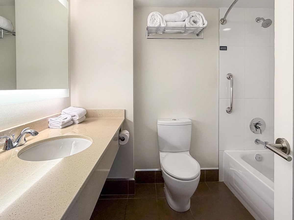 Clean modern bathroom with toilet and tub at Coast Bastion Hotel in Nanaimo.