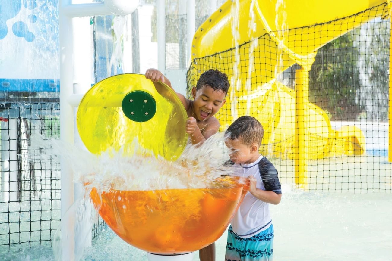 Kids doing water activities in Lazy River on a sunny day at Surfari Water Park Resort