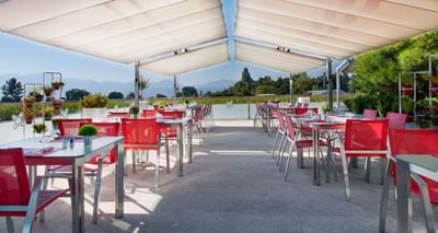Table arrangement on a terrace with a view of a green field at Starling Hotels in Lausanne Switzerland