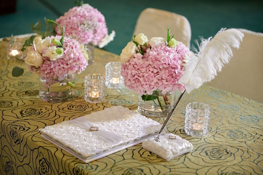 A book on a table with decors at a wedding in Gardens hotels
