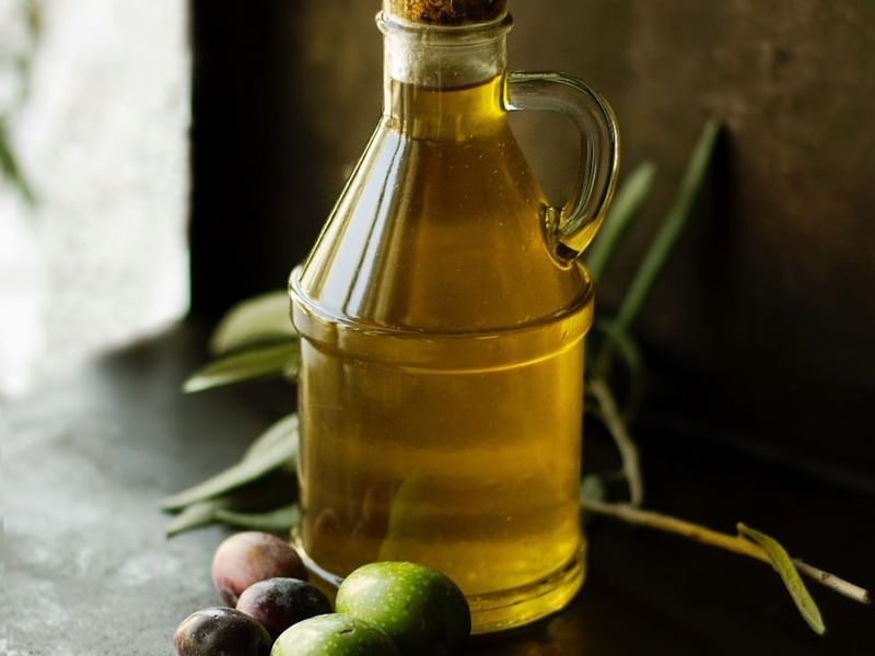 Close-up of olive oil bottle & olives at Falkensteiner Hotels